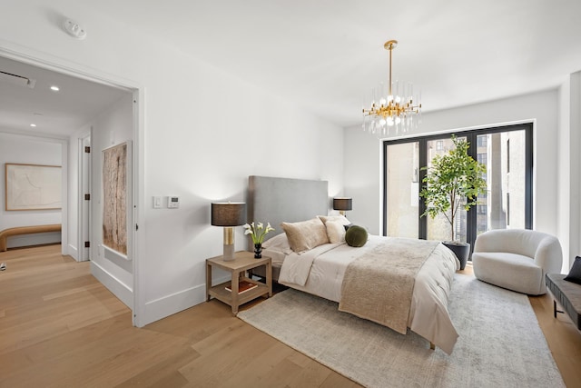 2505 Broadway Unit 2B, New York City, NY 10025 - bedroom featuring a chandelier, access to exterior, recessed lighting, baseboards, and light wood-type flooring