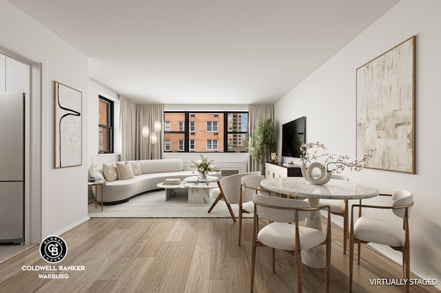 living area with wood finished floors and baseboards