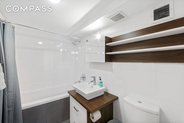 66 N 1st St Unit 1C, New York City, NY 11249 - full bathroom featuring tiled shower / bath, vanity, toilet, and tile walls