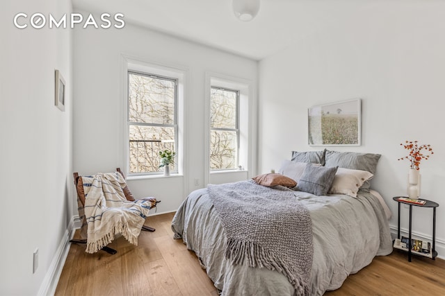 744 Park Pl Unit 4A, New York City, NY 11216 - bedroom featuring light wood-type flooring, multiple windows, and baseboards