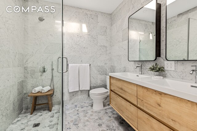 744 Park Pl Unit 4A, New York City, NY 11216 - full bath featuring a stall shower, toilet, double vanity, and tile walls