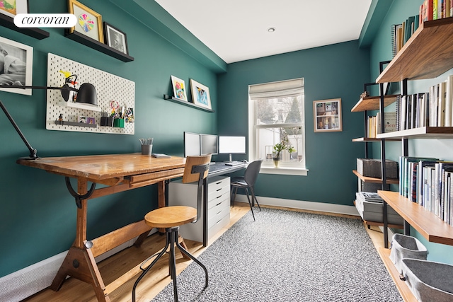 office area with wood finished floors and baseboards
