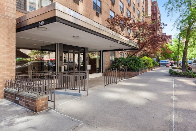 property entrance featuring brick siding