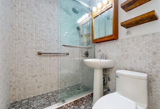 bathroom with walk in shower, toilet, tile walls, and a sink