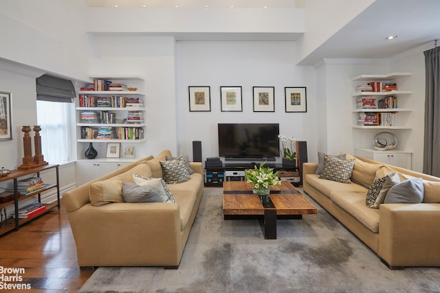 living room featuring ornamental molding, wood-type flooring, recessed lighting, and built in shelves