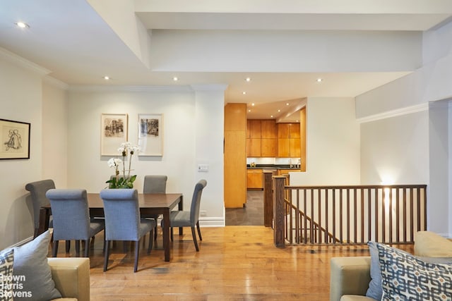 dining room with crown molding, recessed lighting, baseboards, and light wood finished floors