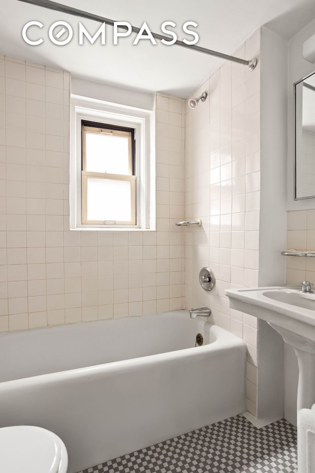 bathroom featuring toilet, shower / bath combination, and tile patterned floors