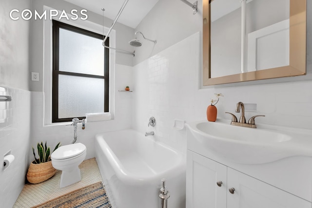 bathroom with vanity, toilet, tile walls, shower / tub combination, and tile patterned floors
