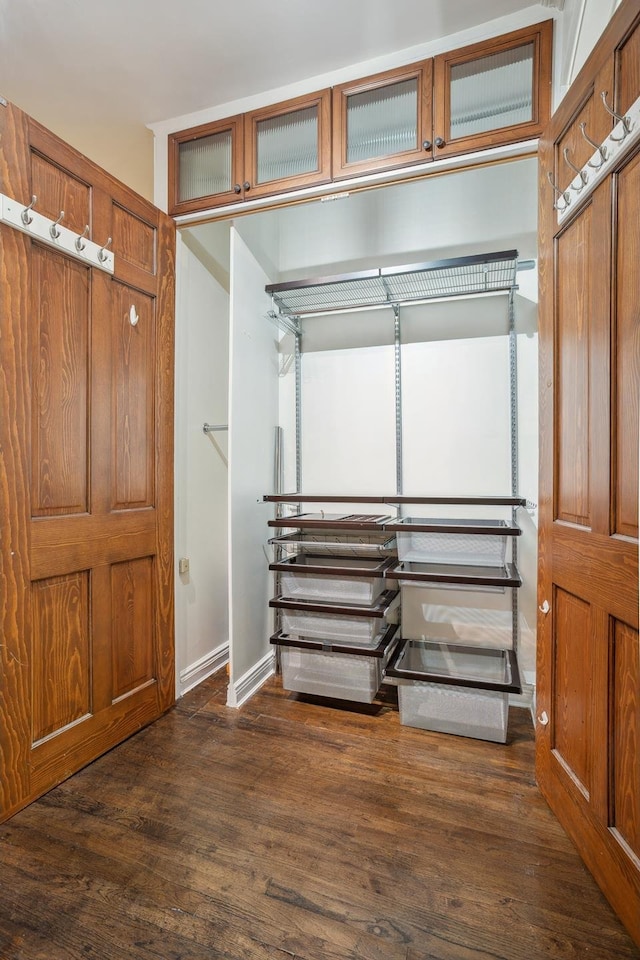 unfurnished bedroom featuring baseboards and dark wood finished floors