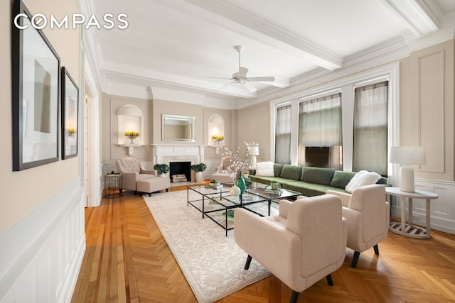 530 W End Ave Unit 9B, New York City, NY 10024 - living room featuring beamed ceiling, a ceiling fan, a fireplace with flush hearth, a decorative wall, and crown molding