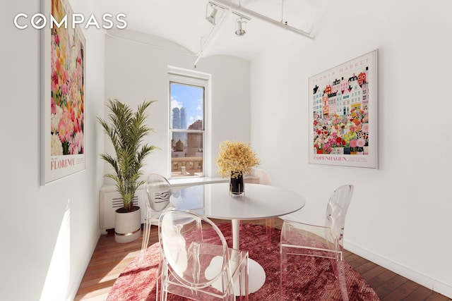 dining room with baseboards and hardwood / wood-style floors