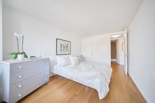 bedroom featuring light wood-type flooring and baseboards