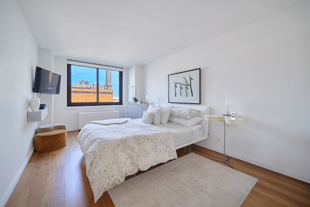 bedroom featuring baseboards and wood finished floors