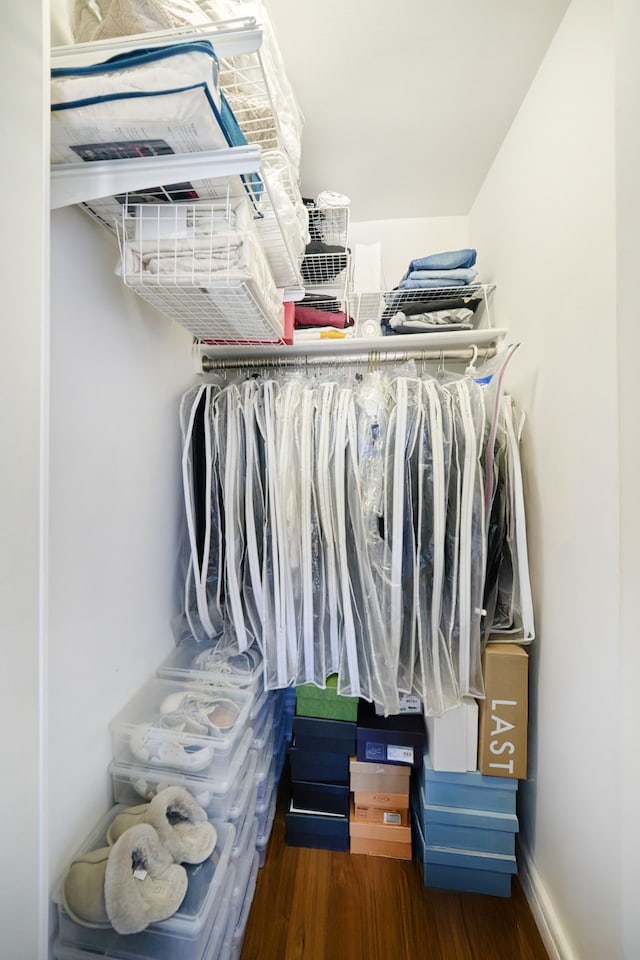 walk in closet with wood finished floors