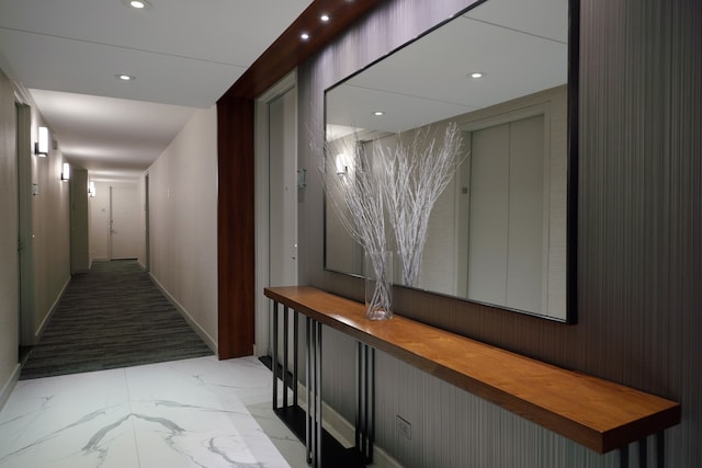 hallway featuring marble finish floors, recessed lighting, and baseboards