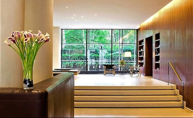 lobby with floor to ceiling windows and stairs