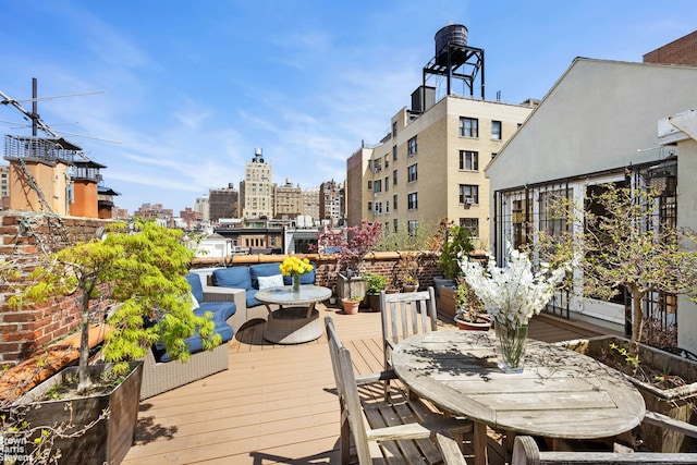 wooden terrace featuring a view of city and an outdoor living space