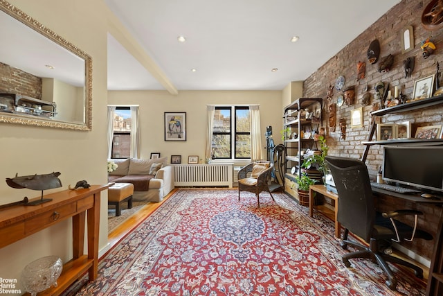 office featuring radiator heating unit, plenty of natural light, wood finished floors, and beam ceiling