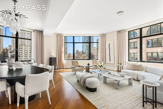 living area with a city view, wood finished floors, and expansive windows