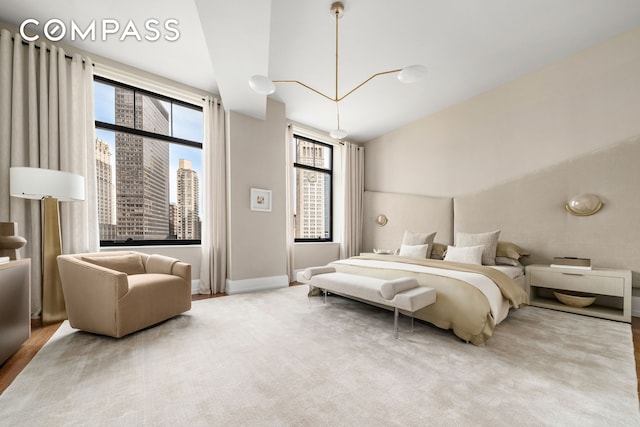 bedroom with vaulted ceiling and a city view