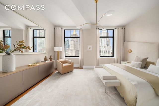 bedroom featuring multiple windows and wood finished floors