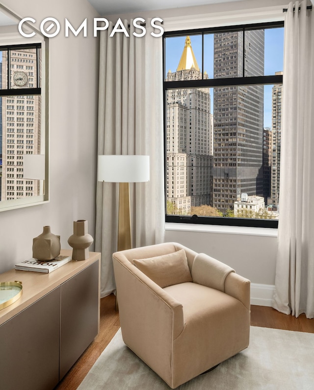 sitting room featuring wood finished floors and a view of city