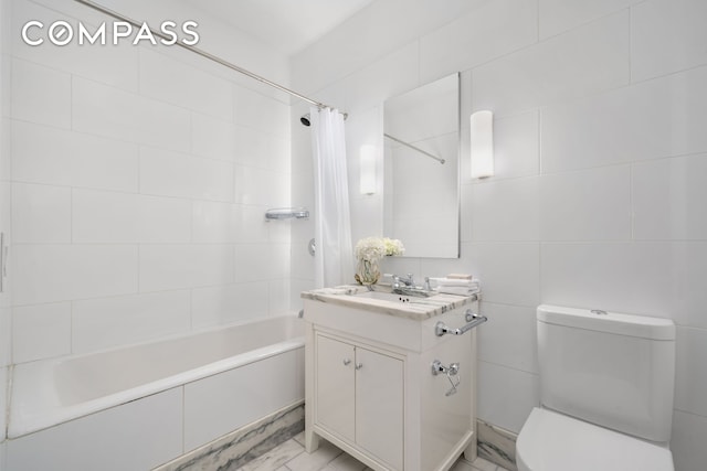 full bath with toilet, marble finish floor, shower / tub combo, and vanity