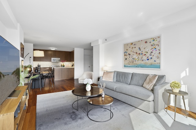 living room featuring dark wood finished floors and baseboards