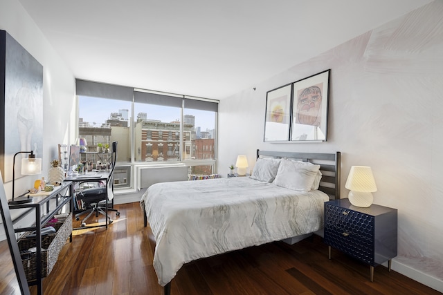 bedroom with wood finished floors and a desk