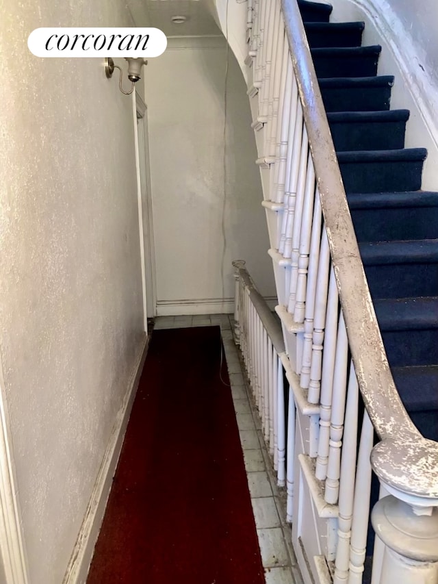 stairway featuring baseboards