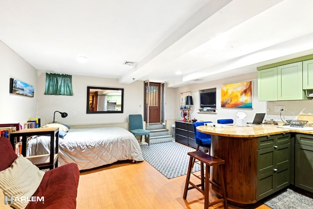 bedroom featuring visible vents and light wood-type flooring