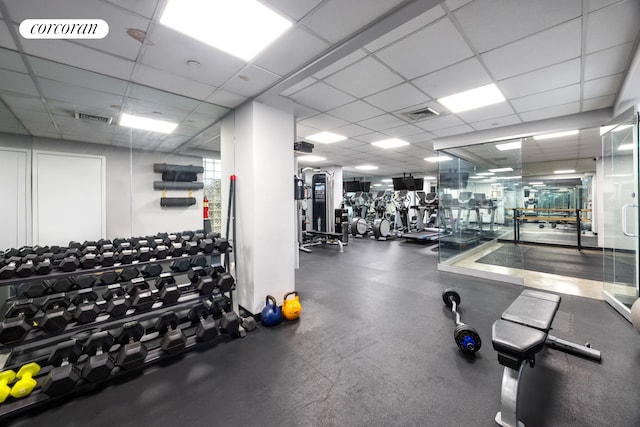 gym with a drop ceiling and visible vents