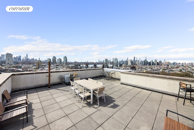view of patio / terrace with a view of city and outdoor dining space