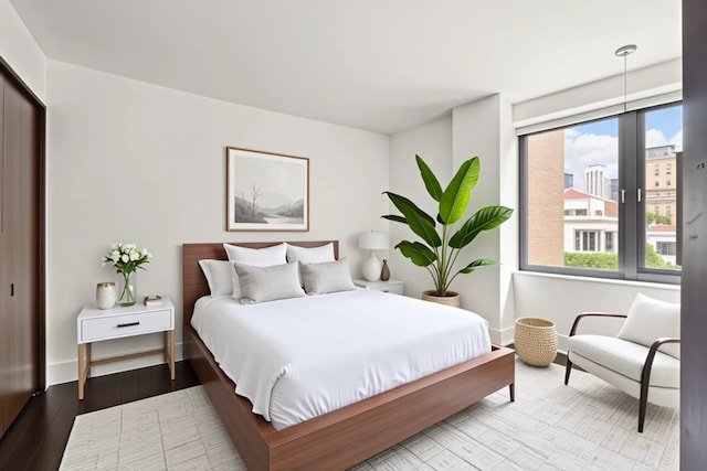 bedroom featuring baseboards and wood finished floors