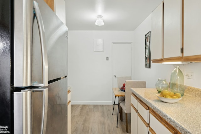 1270 5th Ave Unit 1D, New York City, NY 10029 - kitchen featuring freestanding refrigerator, light wood-style flooring, light countertops, and baseboards