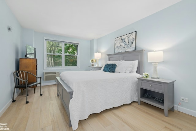 bedroom with light wood-type flooring and baseboards