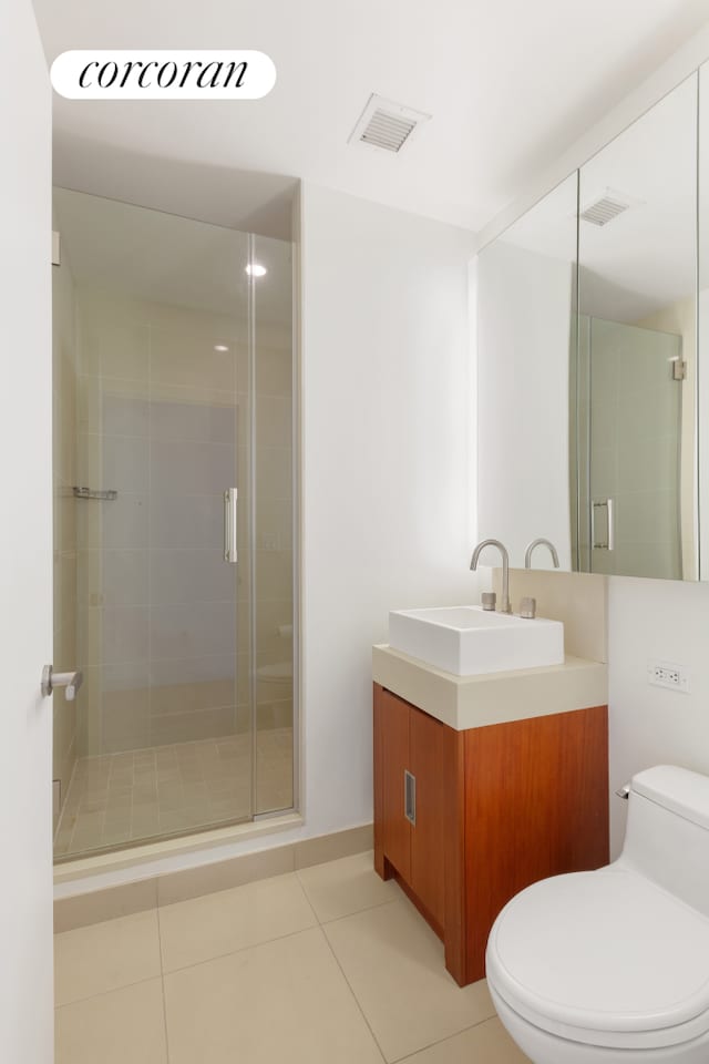 450 W 17th St Unit 2408, New York City, NY 10011 - bathroom featuring vanity, tile patterned floors, and a stall shower
