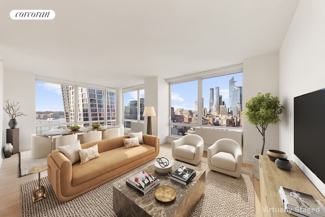 450 W 17th St Unit 2408, New York City, NY 10011 - living room featuring wood finished floors and baseboards