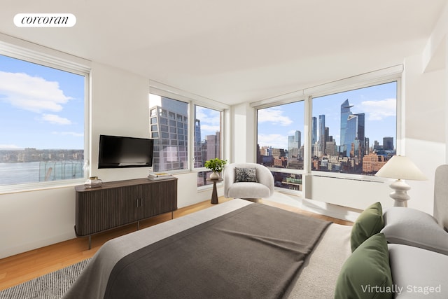 450 W 17th St Unit 2408, New York City, NY 10011 - bedroom with wood finished floors and multiple windows