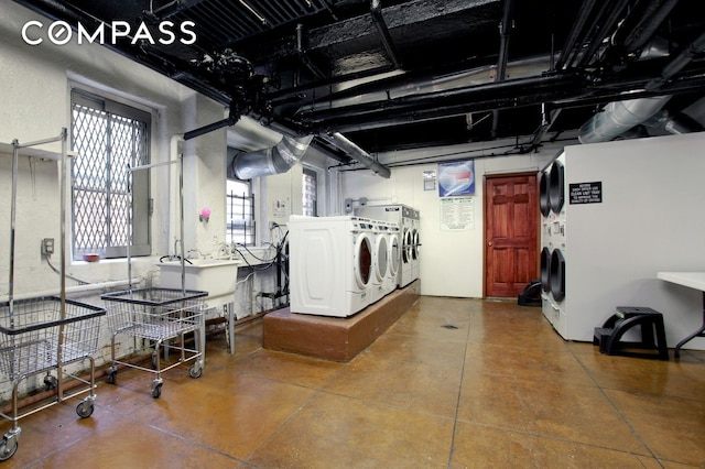 washroom with a sink and washing machine and clothes dryer