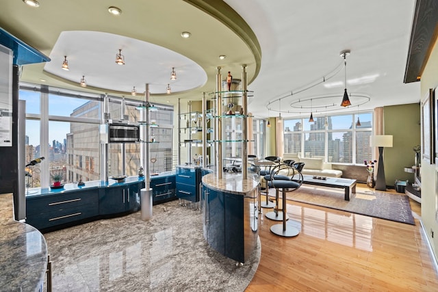 160 W 66th St Unit 34-G, New York City, NY 10023 - interior space featuring a skyline view, wood finished floors, healthy amount of natural light, and recessed lighting