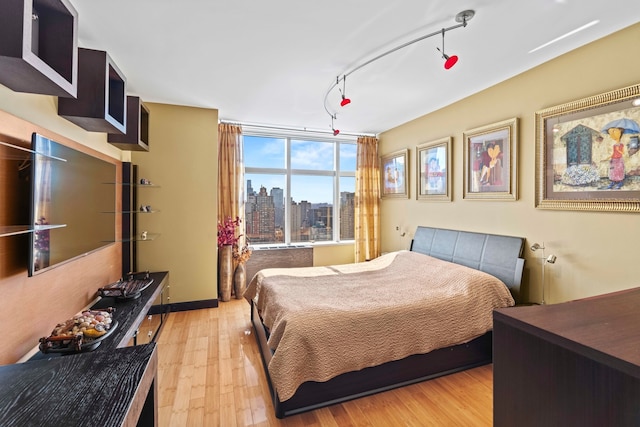 160 W 66th St Unit 34-G, New York City, NY 10023 - bedroom featuring light wood-style flooring and a view of skyline