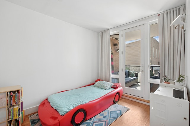 1059 Manhattan Ave Unit 2D, New York City, NY 11222 - bedroom with access to exterior and wood finished floors