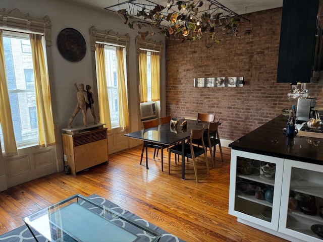 225 S 1st St, New York City, NY 11211 - dining space with hardwood / wood-style floors, healthy amount of natural light, cooling unit, and radiator heating unit
