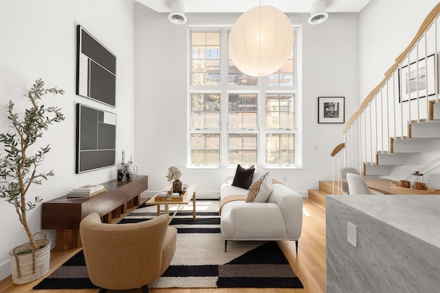 340 Dean St Unit 2B, New York City, NY 11217 - living room with a high ceiling, light wood-type flooring, and stairway