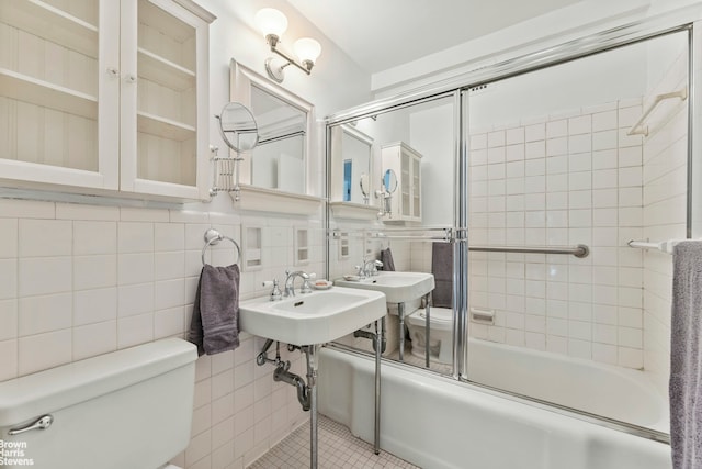 11 Riverside Dr Unit 15Tw, New York City, NY 10023 - full bathroom featuring bath / shower combo with glass door, toilet, and tile walls