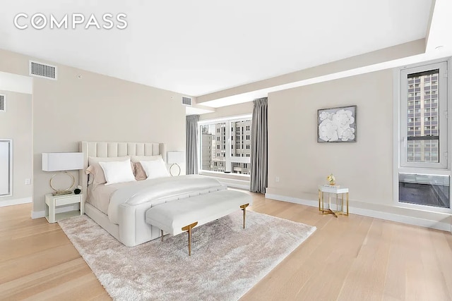 135 W 52nd St Unit 40A, New York City, NY 10019 - bedroom with light wood-style floors and multiple windows