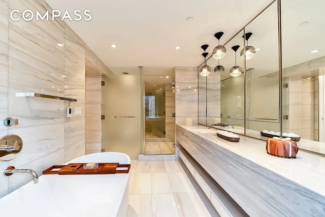 135 W 52nd St Unit 40A, New York City, NY 10019 - full bath featuring a freestanding tub, tile walls, vanity, recessed lighting, and a shower