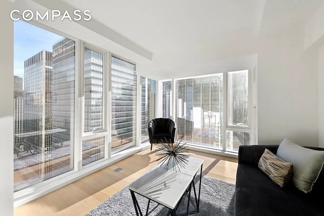 135 W 52nd St Unit 40A, New York City, NY 10019 - living room featuring healthy amount of natural light and wood finished floors