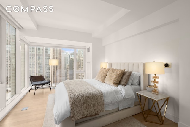 135 W 52nd St Unit 40A, New York City, NY 10019 - bedroom with light wood-type flooring